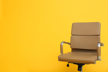Modern office chair on yellow background. Space for text