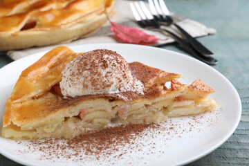 Slice of traditional apple pie with ice cream on plate, closeup