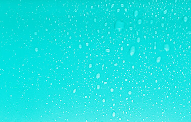 Naklejka na ściany i meble Drops of water on a color background. Blue. Toned