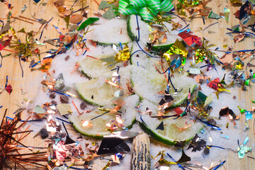 Fototapeta premium Sliced fresh lime decoratef with bright holiday decor as a symbol of festive Christmas tree