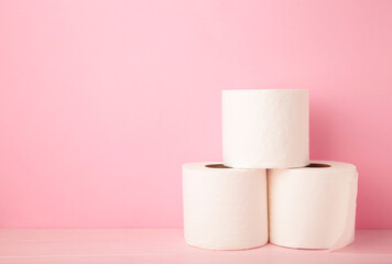 Toilet paper close-up on pink background with copy space