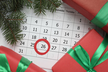 Gifts on calendar with marked Boxing Day date, flat lay
