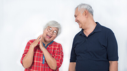 Two happy elderly couple laughing with happiness on white background
