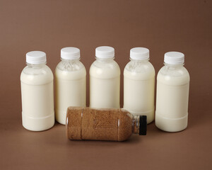 product photo of unlabeled bottled bottles containing kefir milk. one of the bottles contains palm sugar. The combination of the benefits of palm sugar and kefir milk.