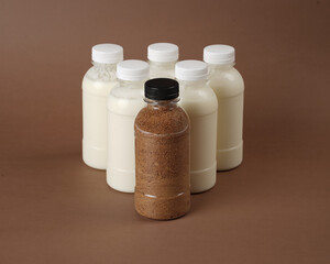 product photo of unlabeled bottled bottles containing kefir milk. one of the bottles contains palm sugar. The combination of the benefits of palm sugar and kefir milk.