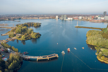 Construction of a bridge at the weerwater lake in the center of Almere, part of the Floriade 2022 expo project. Aerial view. 