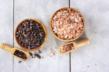 Garam himalaya. A basket of pink and black himalayan salt on wooden table