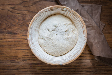 The process of raising the dough in a special basket.Banneton. Dough made from natural sourdough. Wheat dough. Fermentation.