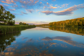 Fototapeta na wymiar Beautiful sunset at the lake, summertime outdoor background