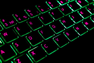 Close up view of a modern laptop computer keyboard key with green buttonss. Pc computer keyboard...