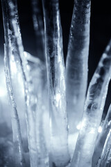 illuminated crystal icicles at dark night