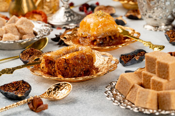 Piece of Turkish baklava in golden arabic plate