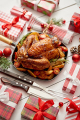 Roasted whole chicken or turkey served in iron pan with Christmas decoration