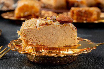 Piece of halva dessert on golden spatula
