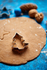 Christmas baking concept. Gingerbread dough with different cutter shapes