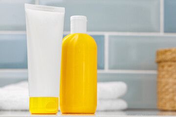 Sunscreen cosmetic containers in bathroom close up