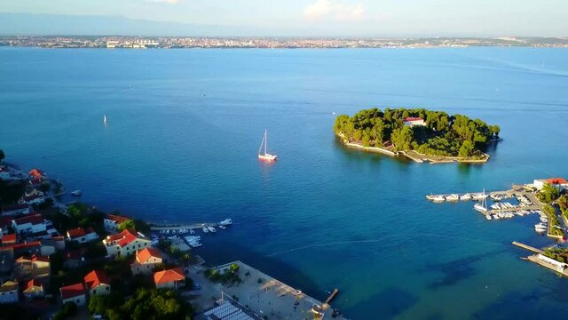 Flight over the city and the port of Preko. Zadar and the Velebit mountains in the background Croatia 4K