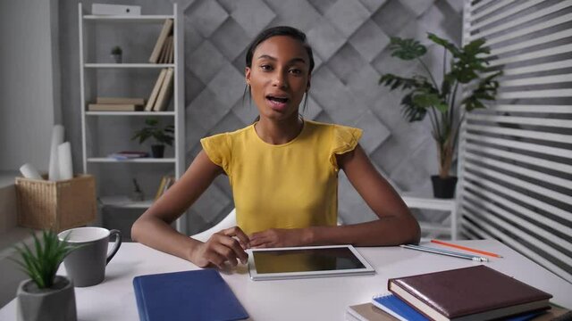 Attractive african american female recruiter communicating with job seeker during online interview via video chat. Mixed race HR employee meeting with job applicant using zoom conference
