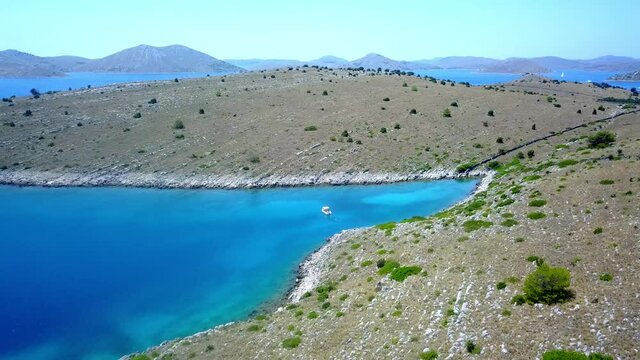 Flight over the Kornati islands group boat moored in a bay Croatia 4K