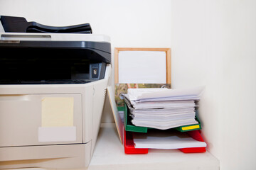 Close-up of printer and paperwork in real life office