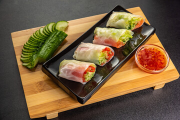 vietnamese spring rolls with Salmon and sauce on gray background
