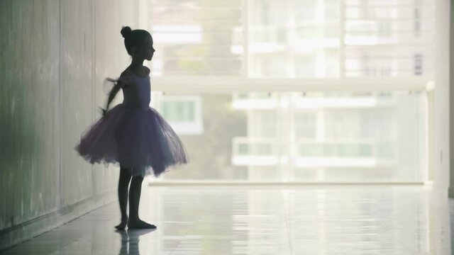 Charming little girl ballerina in a magnificent dress dancing ballet dance