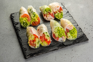 vietnamese spring rolls with Salmon on gray background
