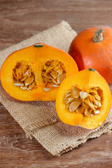 Labu kabocha. Ripe pumpkin, sliced pumpkin, pumpkin on the old board background