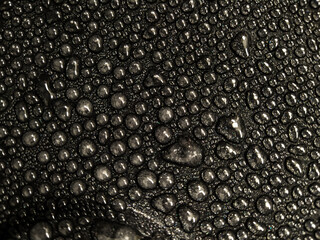 Water drops on black glass background