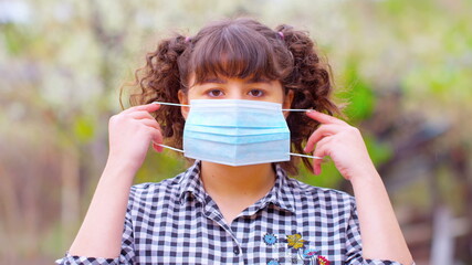 Girl Takes Off Medical Mask For Covid 19 virus photo, still, image. Coronavirus pandemic. NCOV.