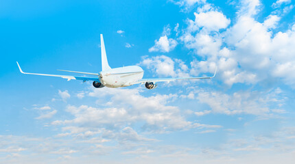 White passenger airplane over the clouds  - Travel by air transport