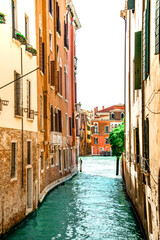 Fototapeta na wymiar Sunny Venice, Italy. Old colorful buildings, narrow streets and bridges. Monuments of Venice