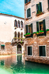 Fototapeta na wymiar Sunny Venice, Italy. Old colorful buildings, narrow streets and bridges. Monuments of Venice