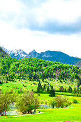 Fototapeta na wymiar Summer in Slovenia. Mountain path. Green hills and cloudy skies. Triglav National Park, Julian Alps, Slovenia.