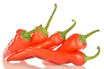 Several red sweet, natural peppers, close-up, isolated on white.