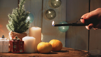 Small Christmas tree and candles on a wooden background