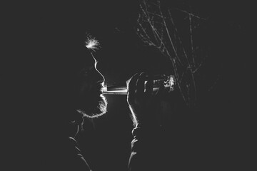 back lit portrait of a man drinking beer