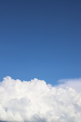 White thick clouds and blue sky background. Sunny day