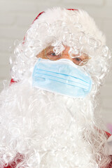 man in Santa claus costume wearing safety gauze medical face mask.