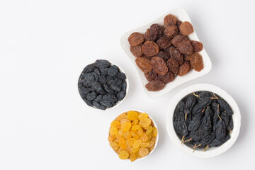 Dried fruits, raisins on white background