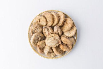 Dried fig on plate on white background