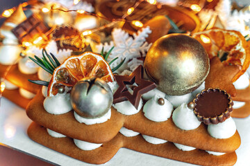 Cake for the new year. New Year's cake. Cake among the New Year's lights. Close-up christmas cake decoration