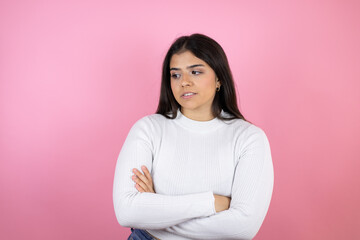 Fototapeta premium Young beautiful woman over isolated pink background thinking looking tired and bored with crossed arms