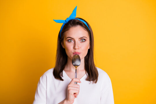 Photo of funky young girl hold spoon mouth look camera wear blue headband white t-shirt isolated yellow color background
