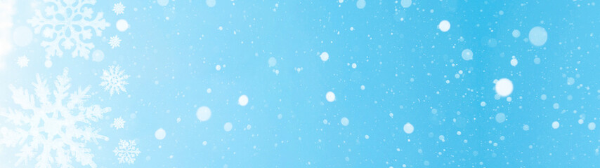 snowflakes and ice crystals isolated on blue sky illuminated by the sun - winter background panorama banner long