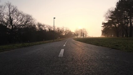 Empty Road in Suburbia on Sunrise Sunlight, Cinematic Low Angle View.