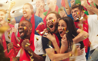 Group of happy fans cheering for their team victory. Male and female models as fans of football or...