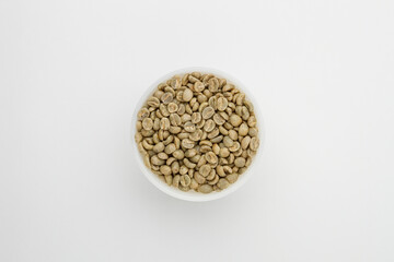 Specialty green coffee beans from Kenya on a white background