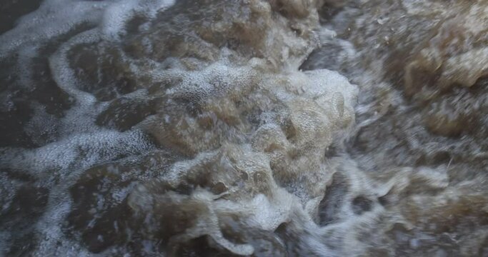 Forms arising from swirling water in septic purification tank. 4K slow motion.
