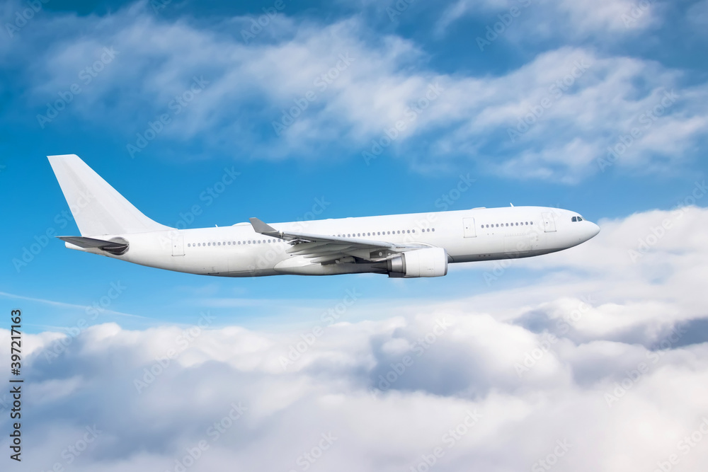 Wall mural flying a aircraft over fluffy cumulus clouds, aerial view.